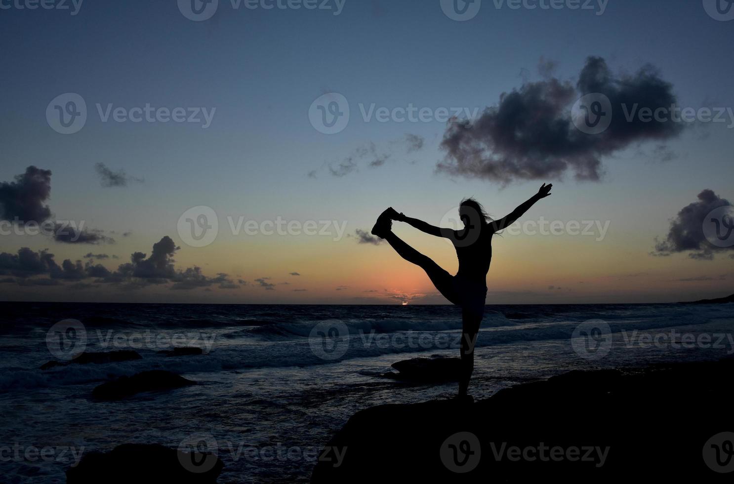 Toe de yoga mantenga la pose de equilibrio recortada al amanecer. foto