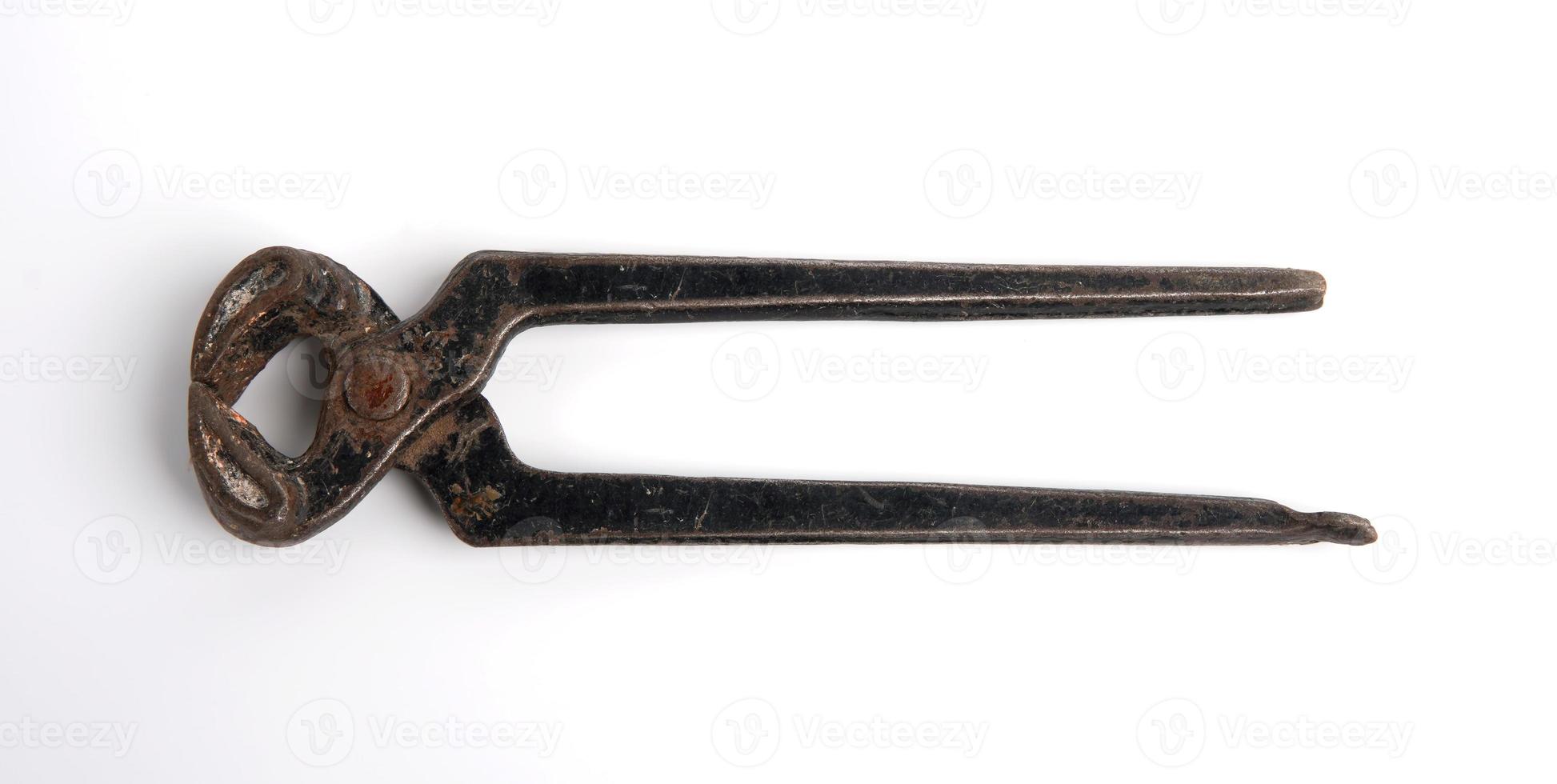 Carpenters pincers, tool old black metal tongs with rust isolated on white background photo