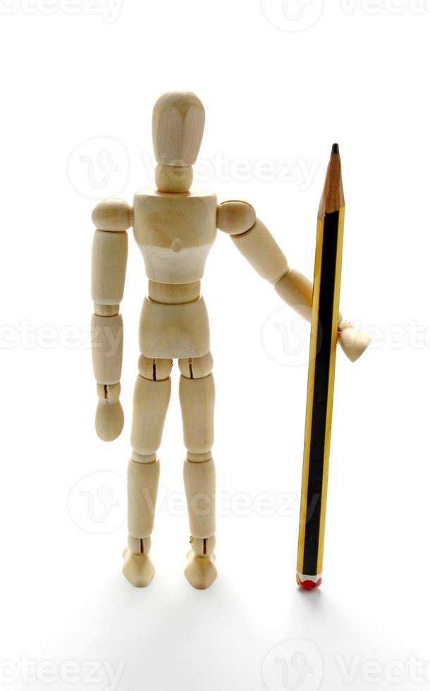 Wooden mannequin holding a pencil photo