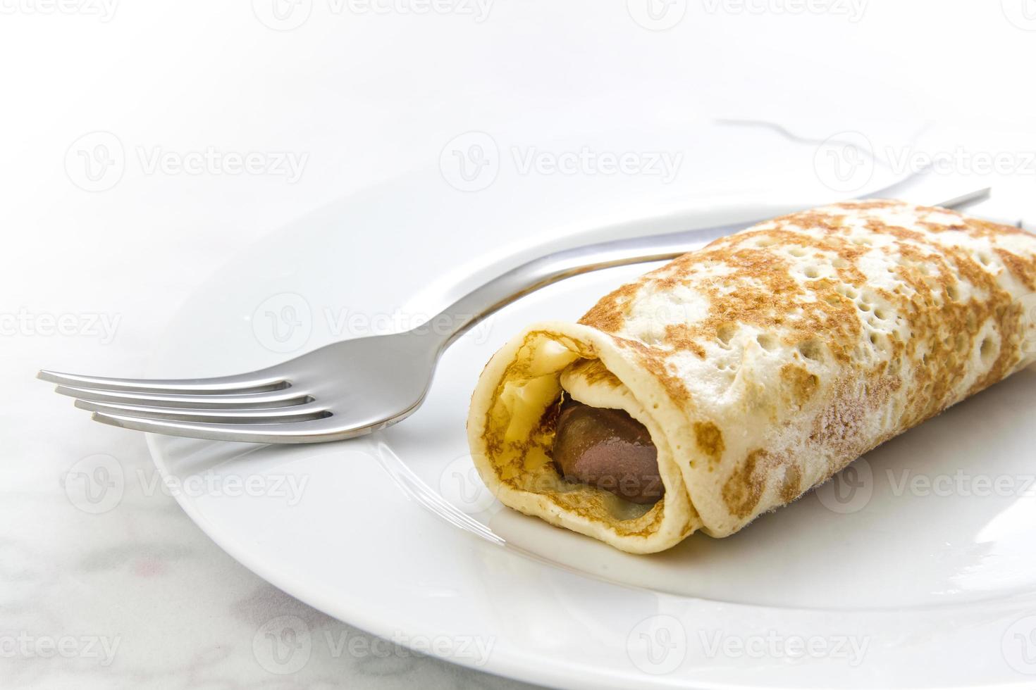 Crepe and fork on dish photo