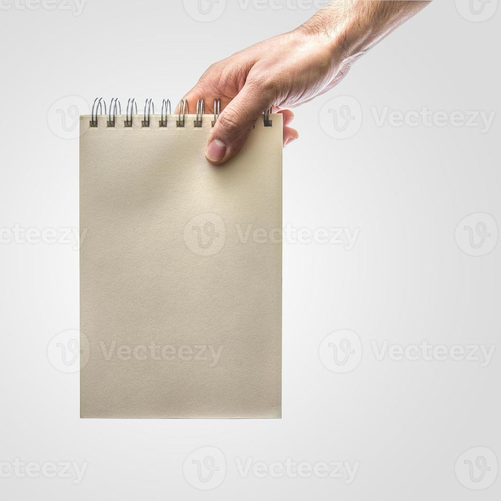 Hand holding notebook photo