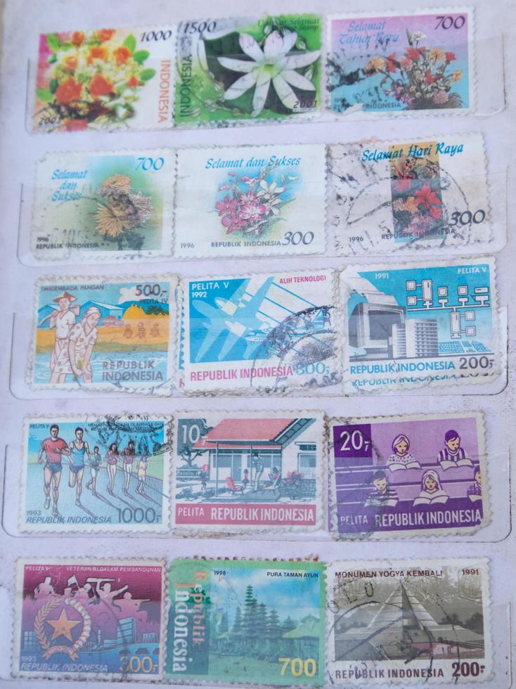 Sidoarjo, Jawa timur, Indonesia, 2022 - close-up photo of a collection of old school stamps from time to time packaged in a stamp book