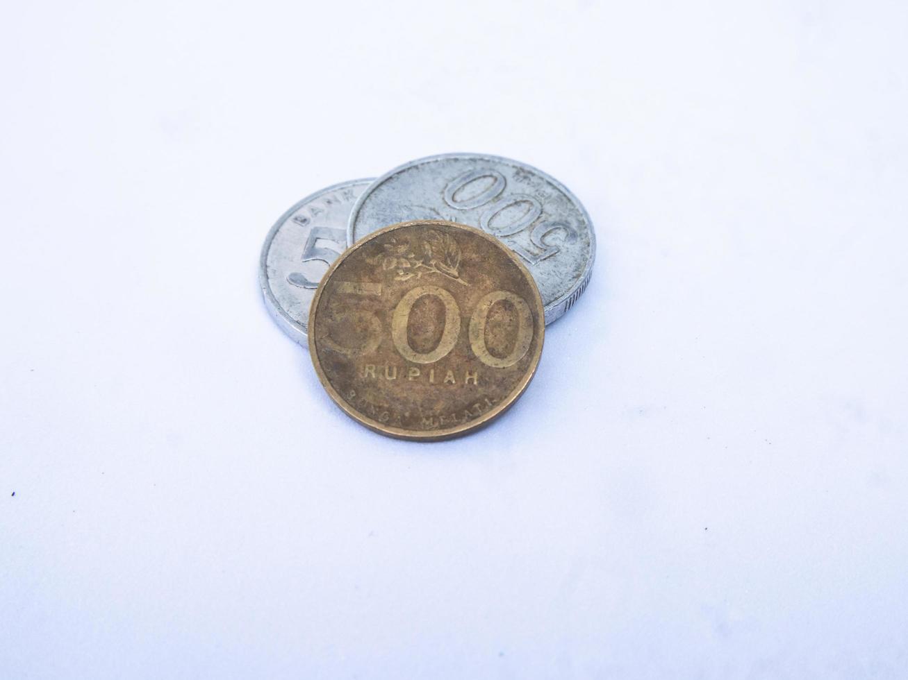 Close-up photo of a collection of 500 rupiah coins, Indonesian currency isolated on a white background