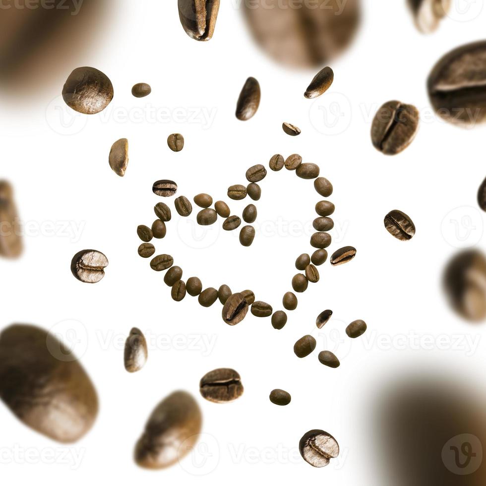 Coffee beans in the shape of a heart in flight on a white background photo