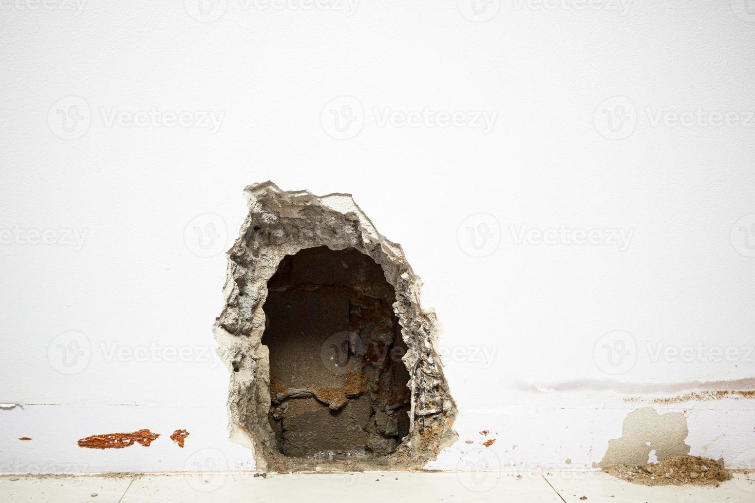 Concrete walls in the shade that have been smashed or destroyed to find holes for water leaks. Home repair concept. photo