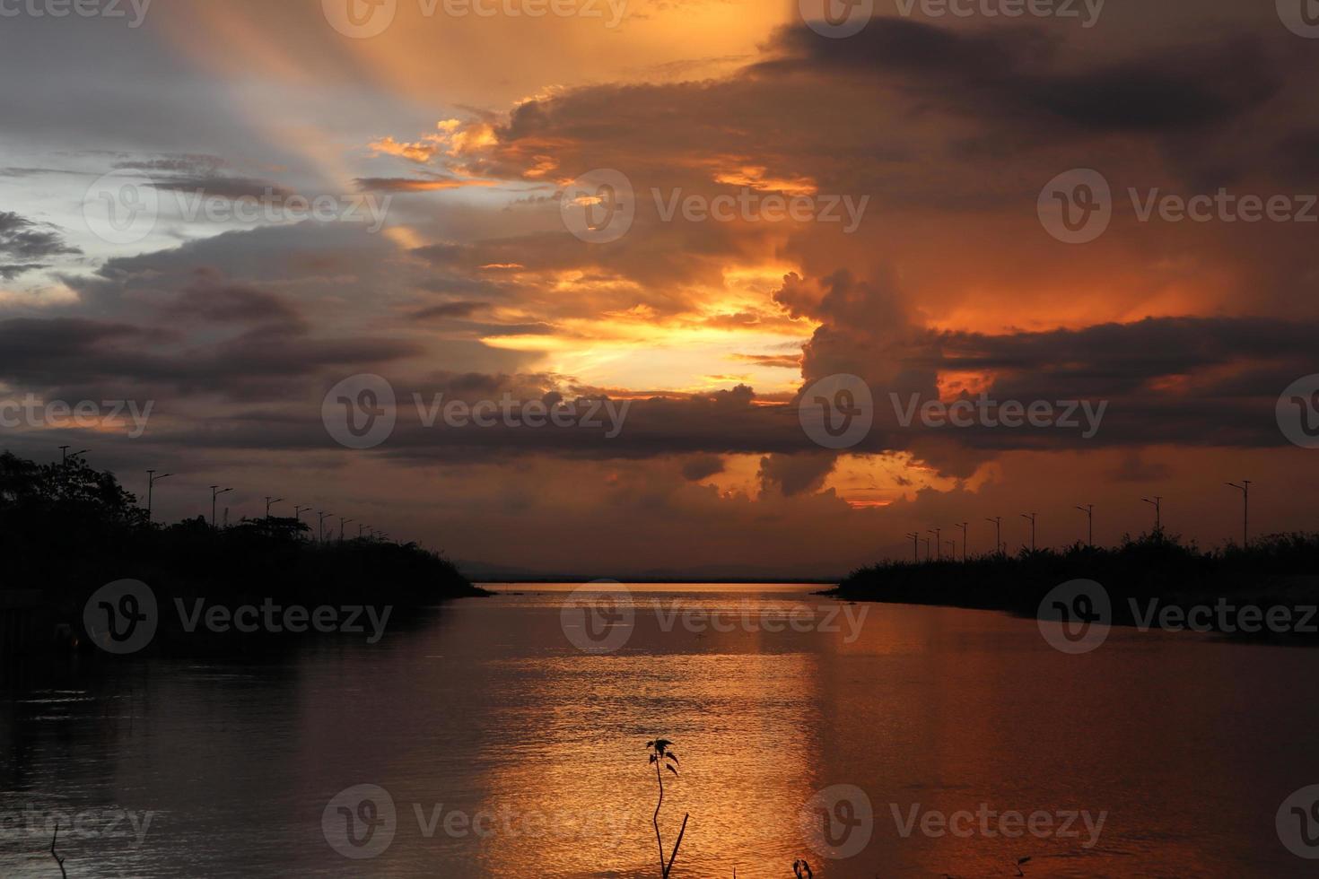 colorful dramatic sky with clouds at sunset. Sunset in  the lake photo