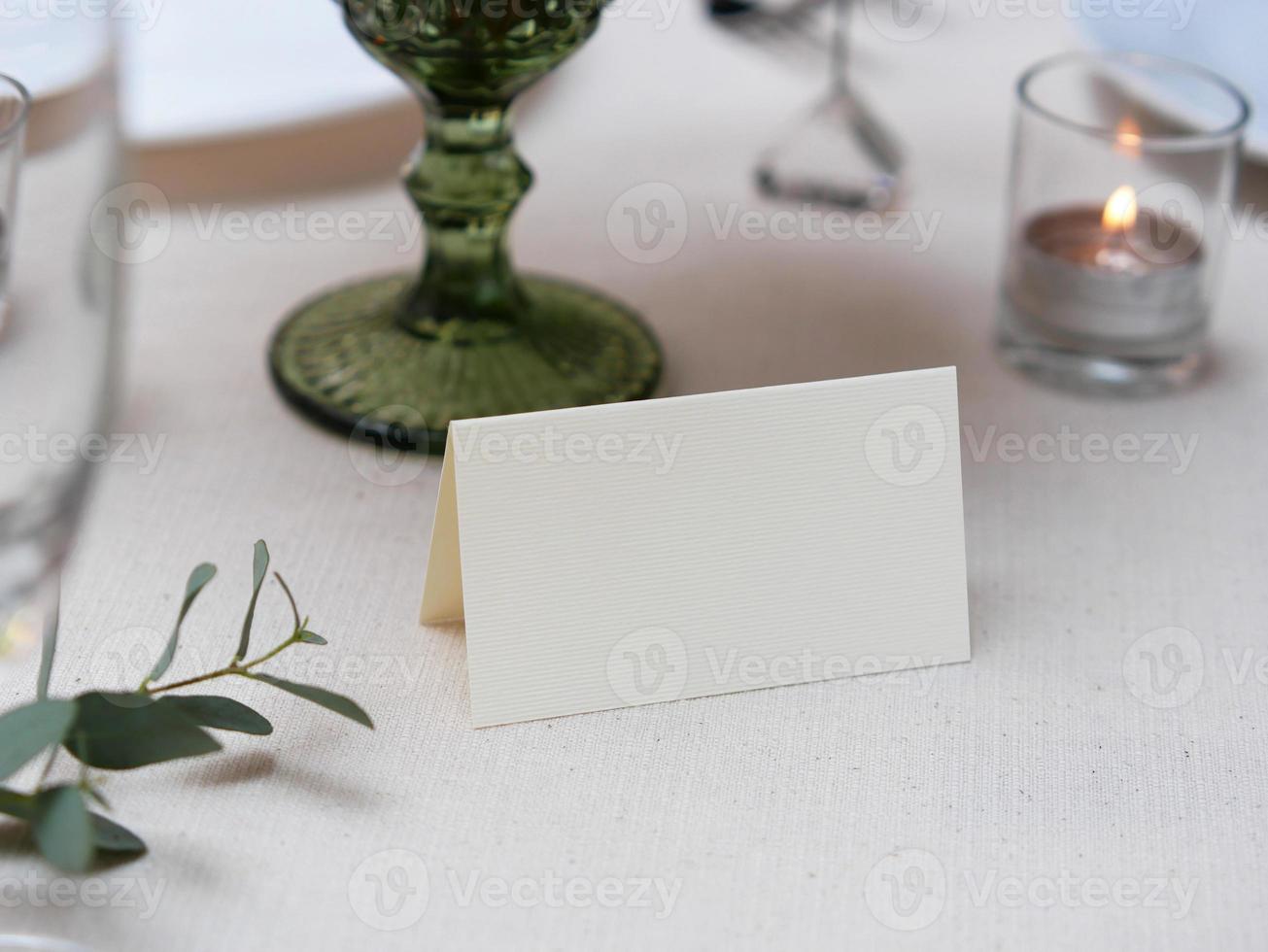 Mockup white blank space card on table setting with clipping path photo