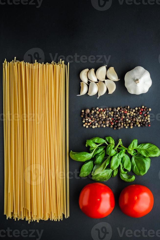 Pasta ingredients concept on black background photo
