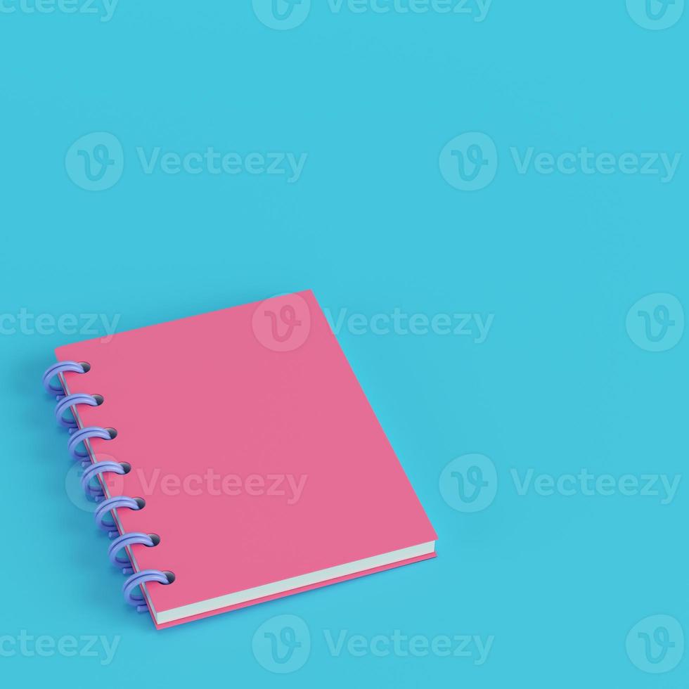 Pink notepad on bright blue background in pastel colors photo