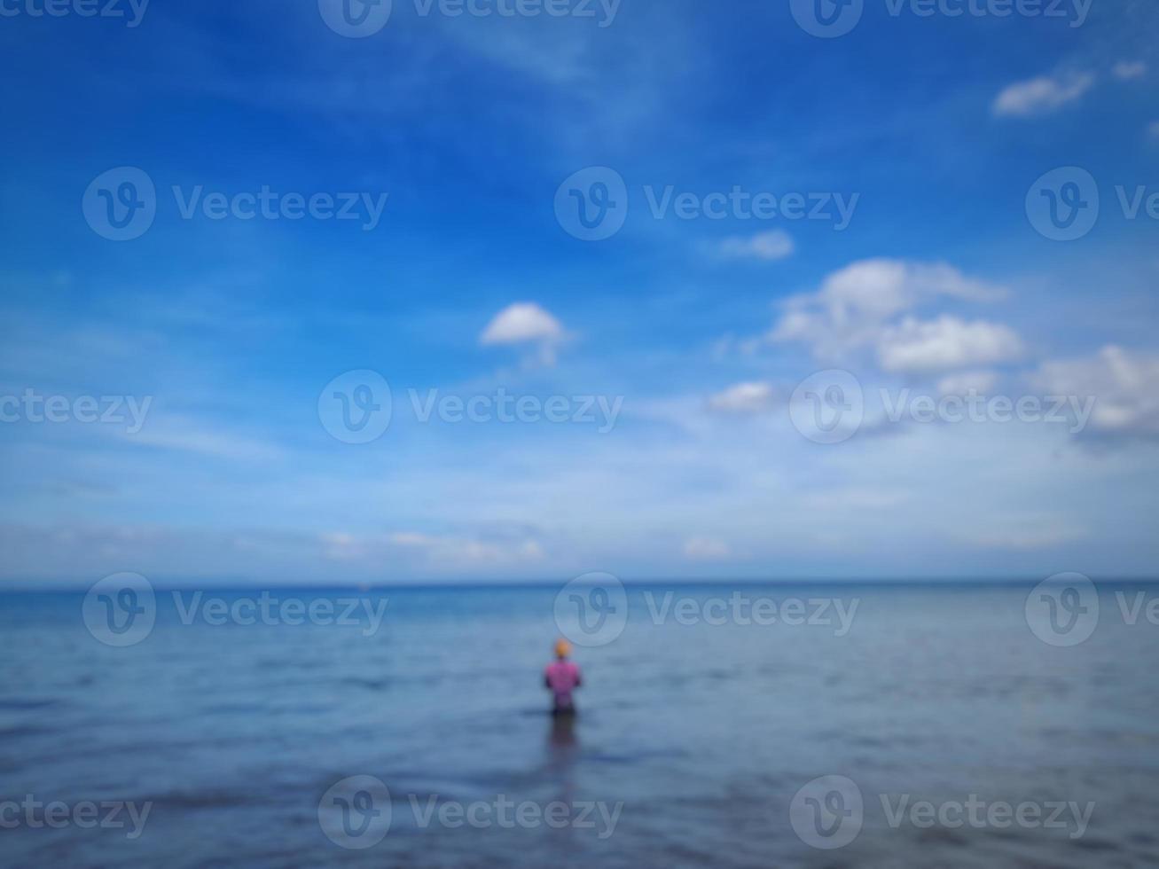 defocused abstract background of fishing at the beach with the clearly blue sky photo