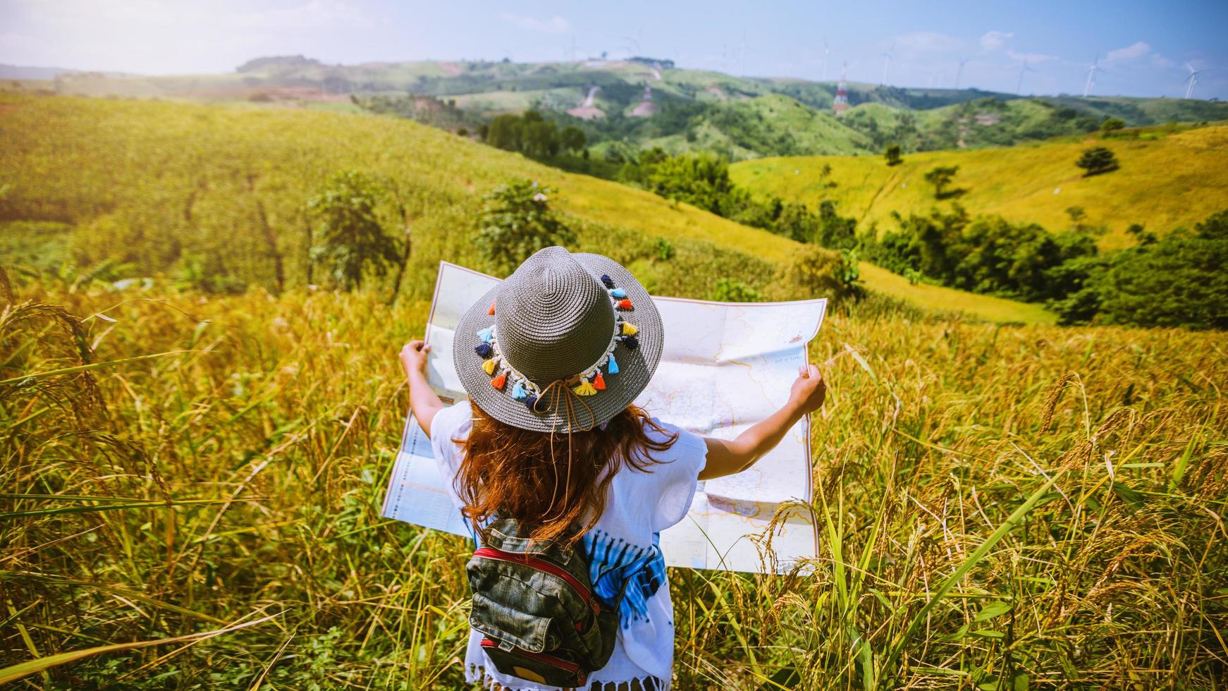 Asian women travel Rice fields green On the mountains in the holiday. happy and enjoying a beautiful nature. Rice fields Golden. Travel with a map of Asian girls. summer photo