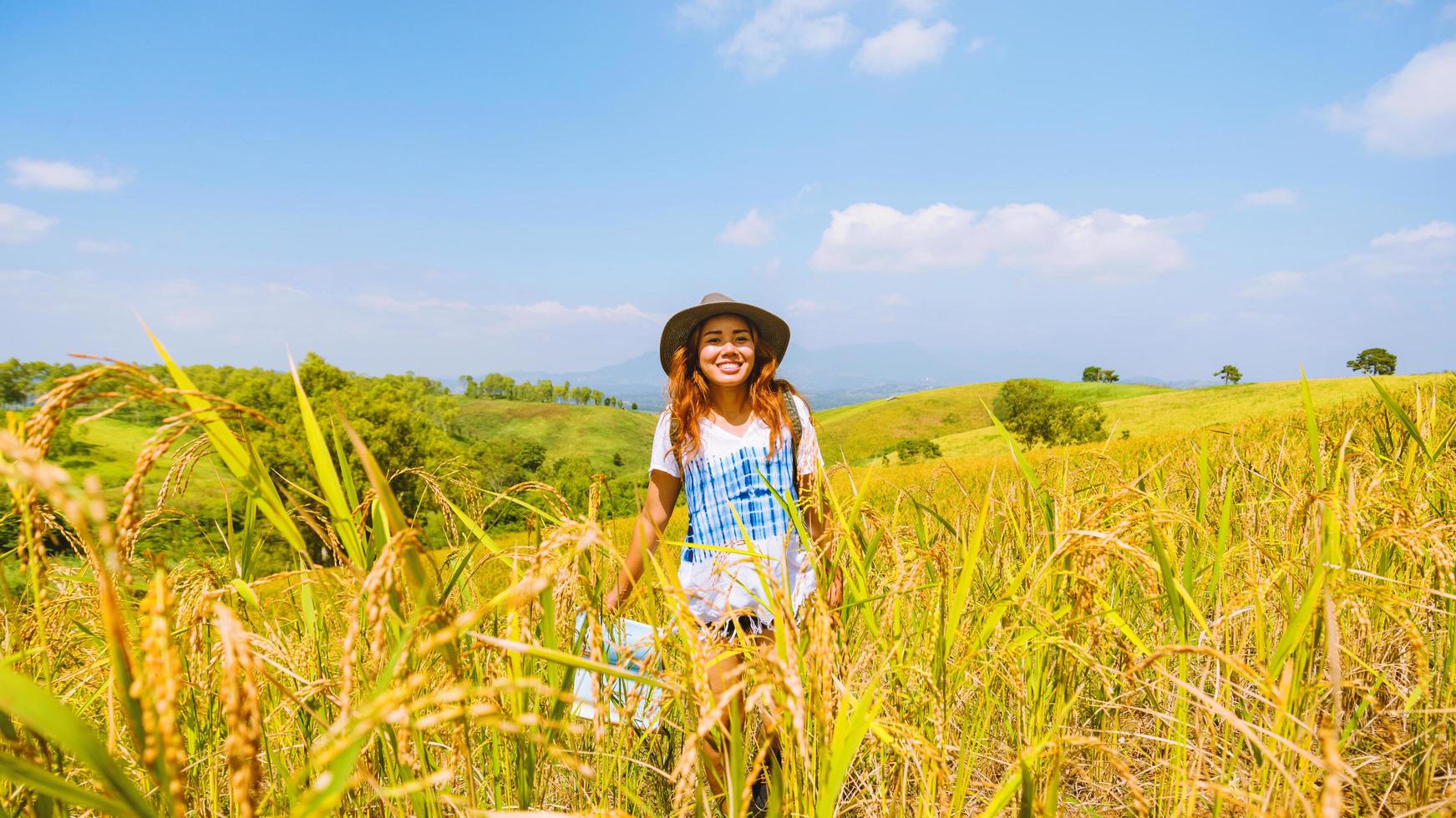 Asian women travel relax in the holiday. Stand natural touch mountain field summer. View map travel explore. In Thailand photo