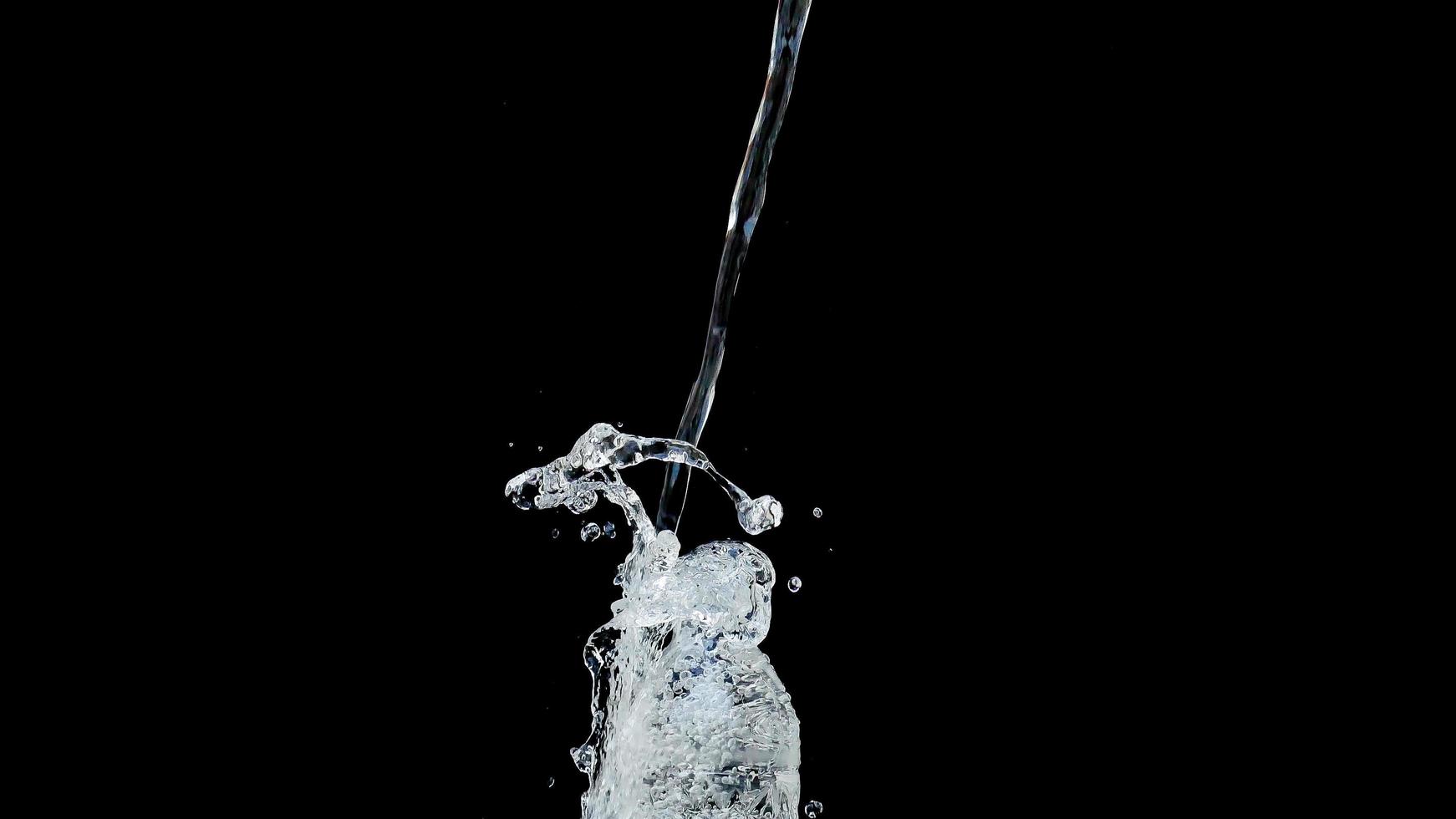 Abstract water jet crashes on a black background photo