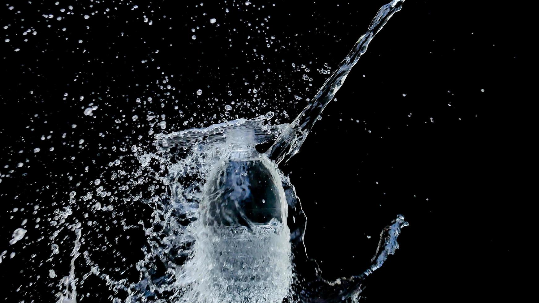 Abstract water jet crashes on a black background photo