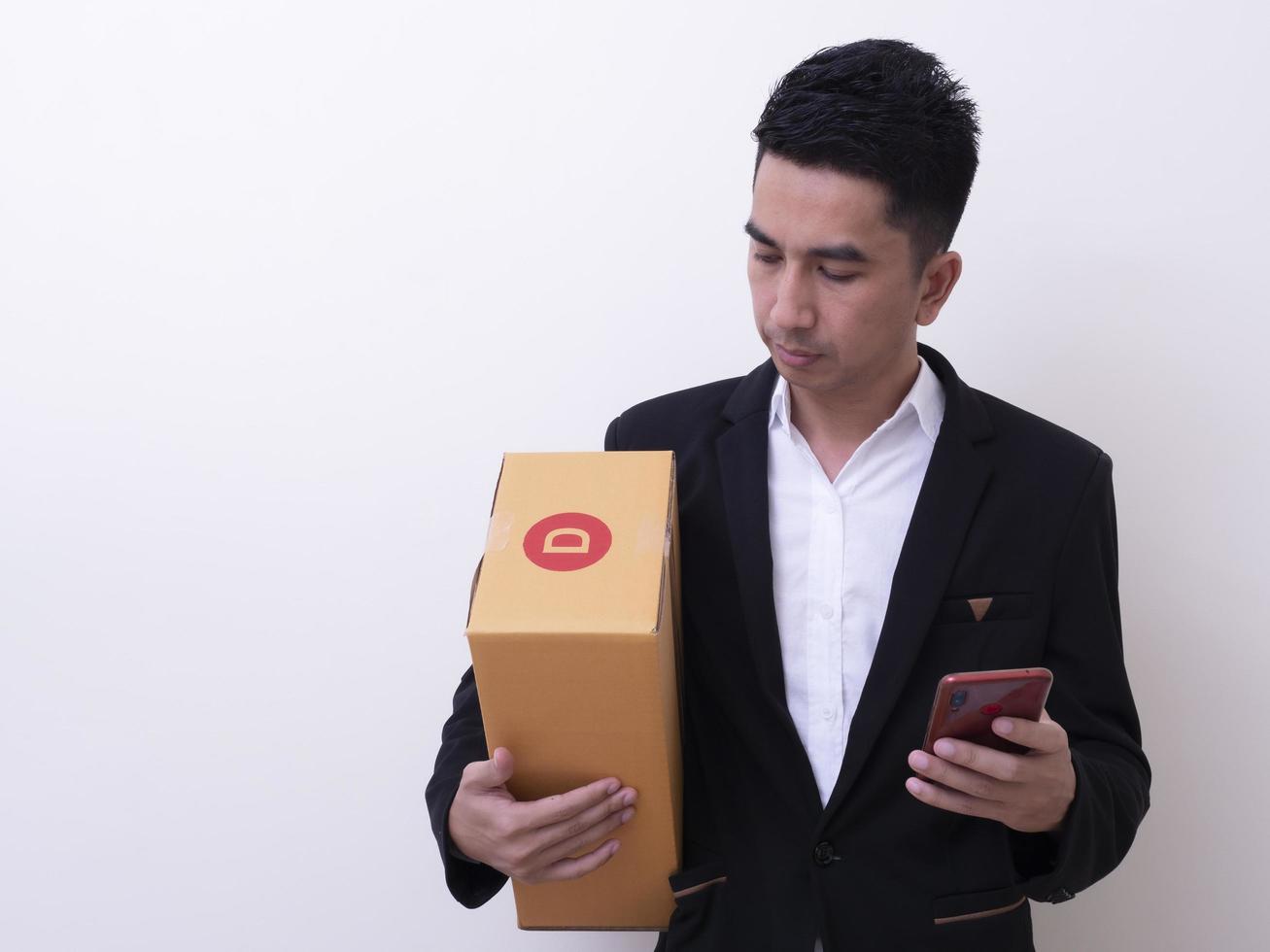 Shipper young Asian man holding cardboard box photo