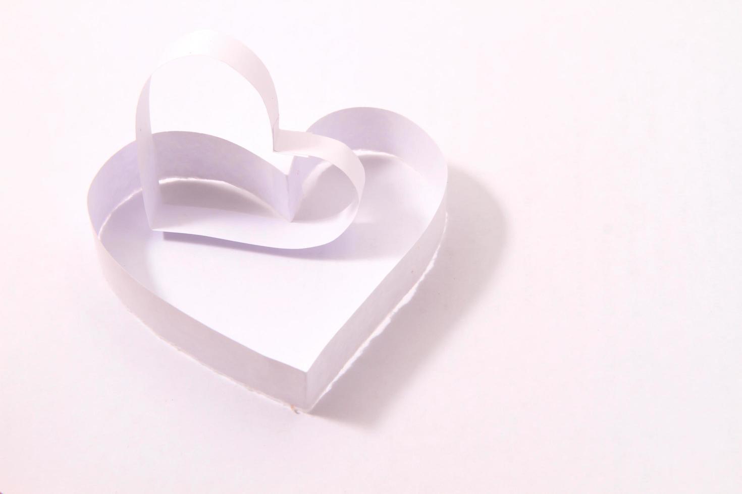 Paper hearts on white background photo