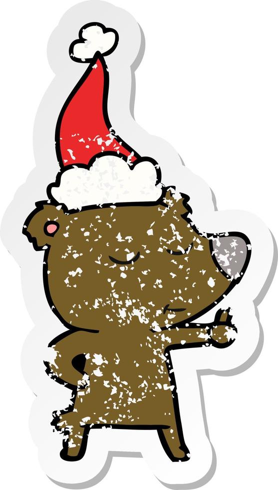 happy distressed sticker cartoon of a bear giving thumbs up wearing santa hat vector
