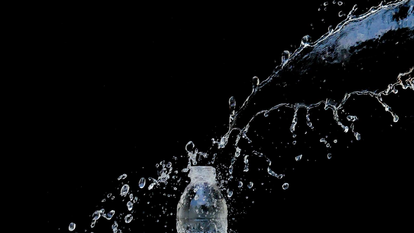 Abstract water jet crashes on a black background photo