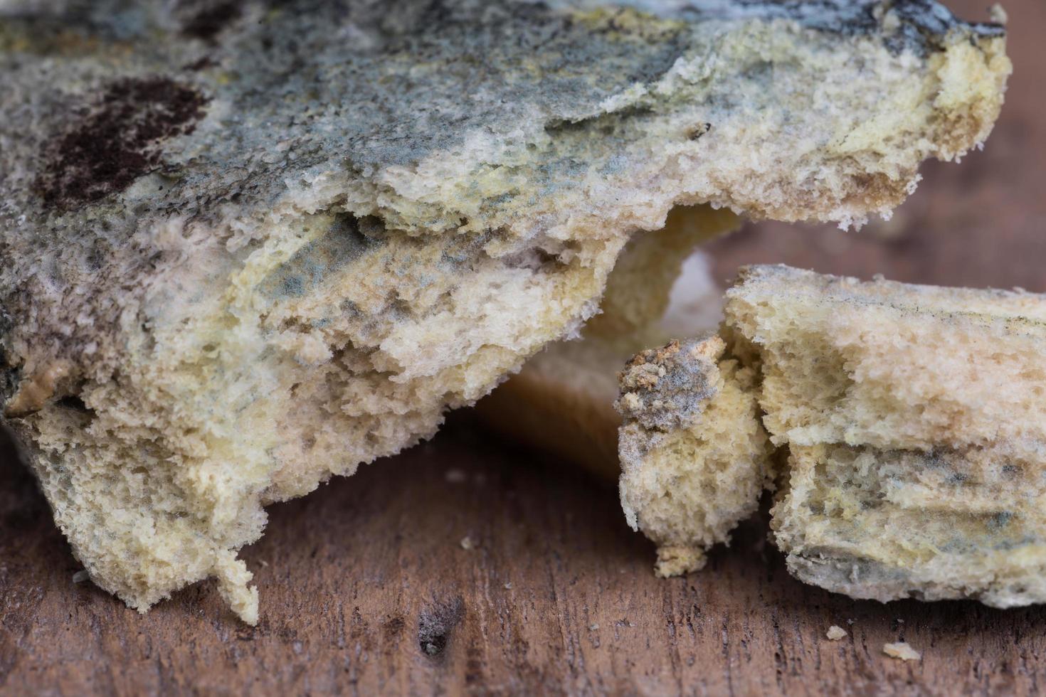 Mouldy bread on cutting board photo