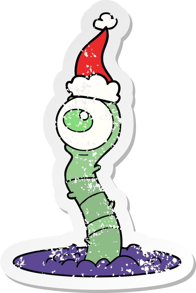 distressed sticker cartoon of a alien swamp monster wearing santa hat vector