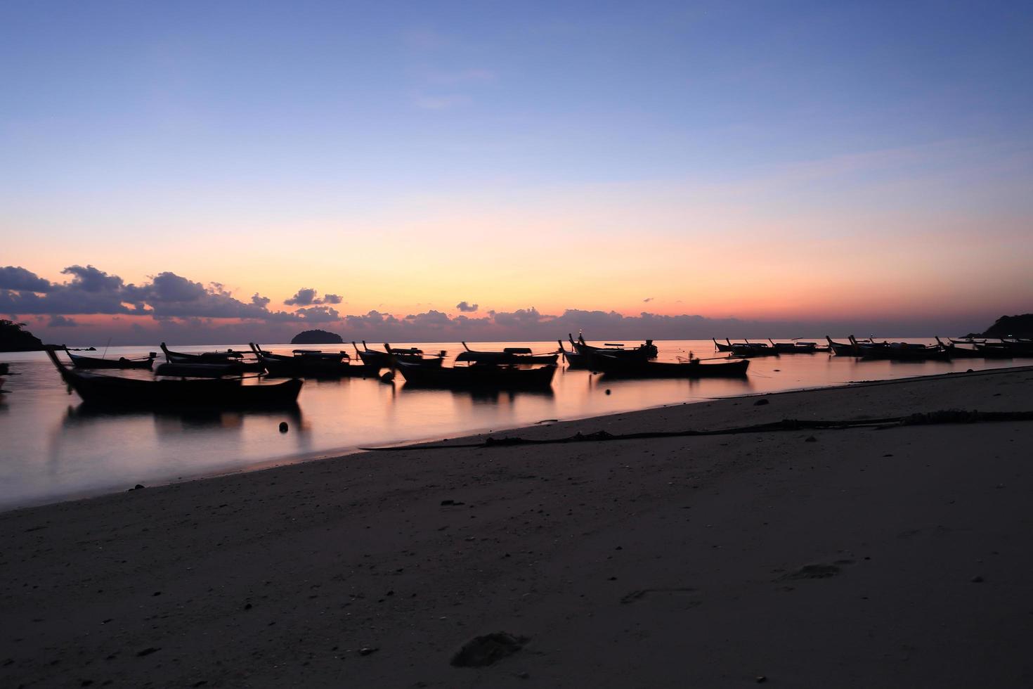 long tail boats at sunset at Koh Lipe photo