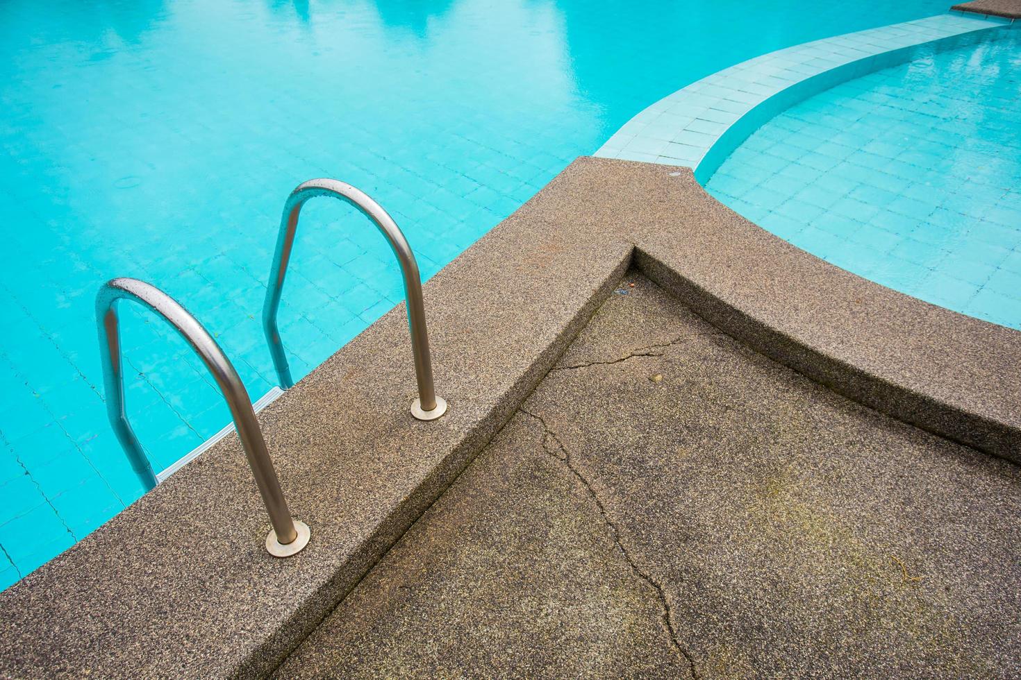 Swimming pool with stair at hotel close up photo