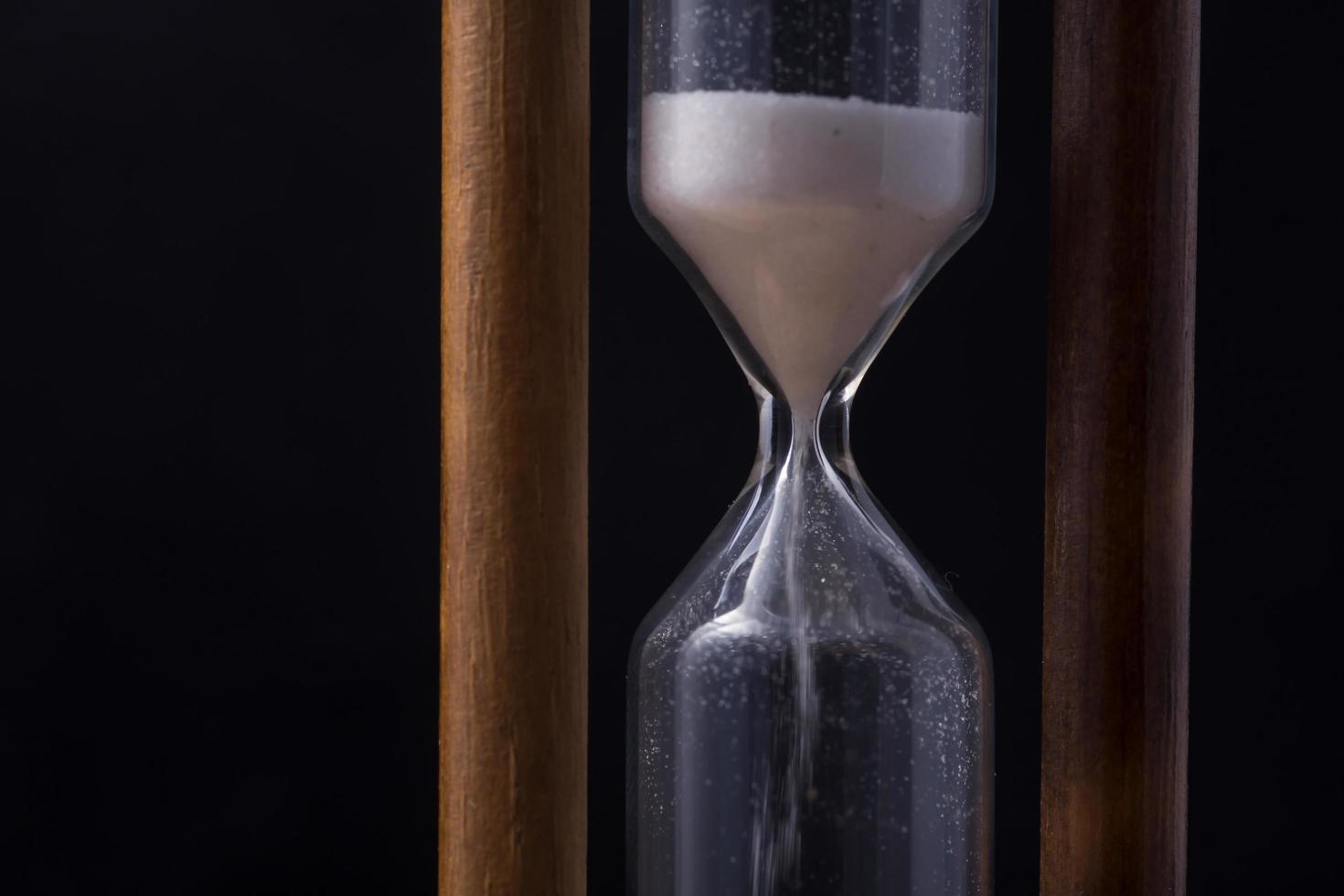 sand falling in hour glass photo