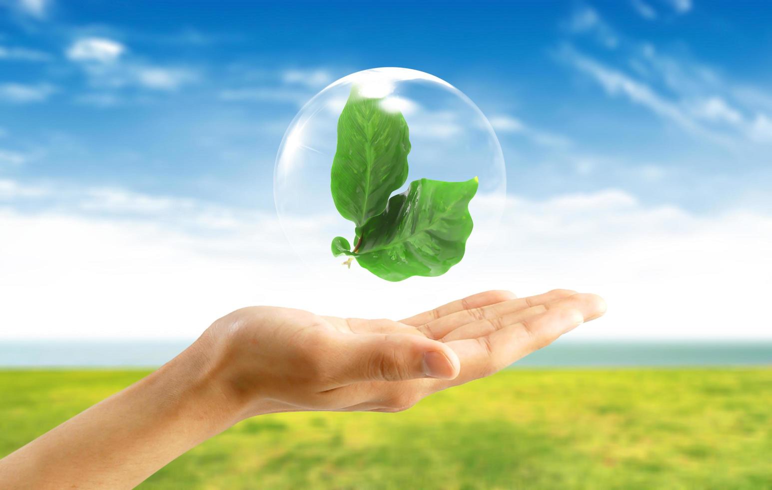 Abstract bubbles against   Symbol of environmental protection on hand photo