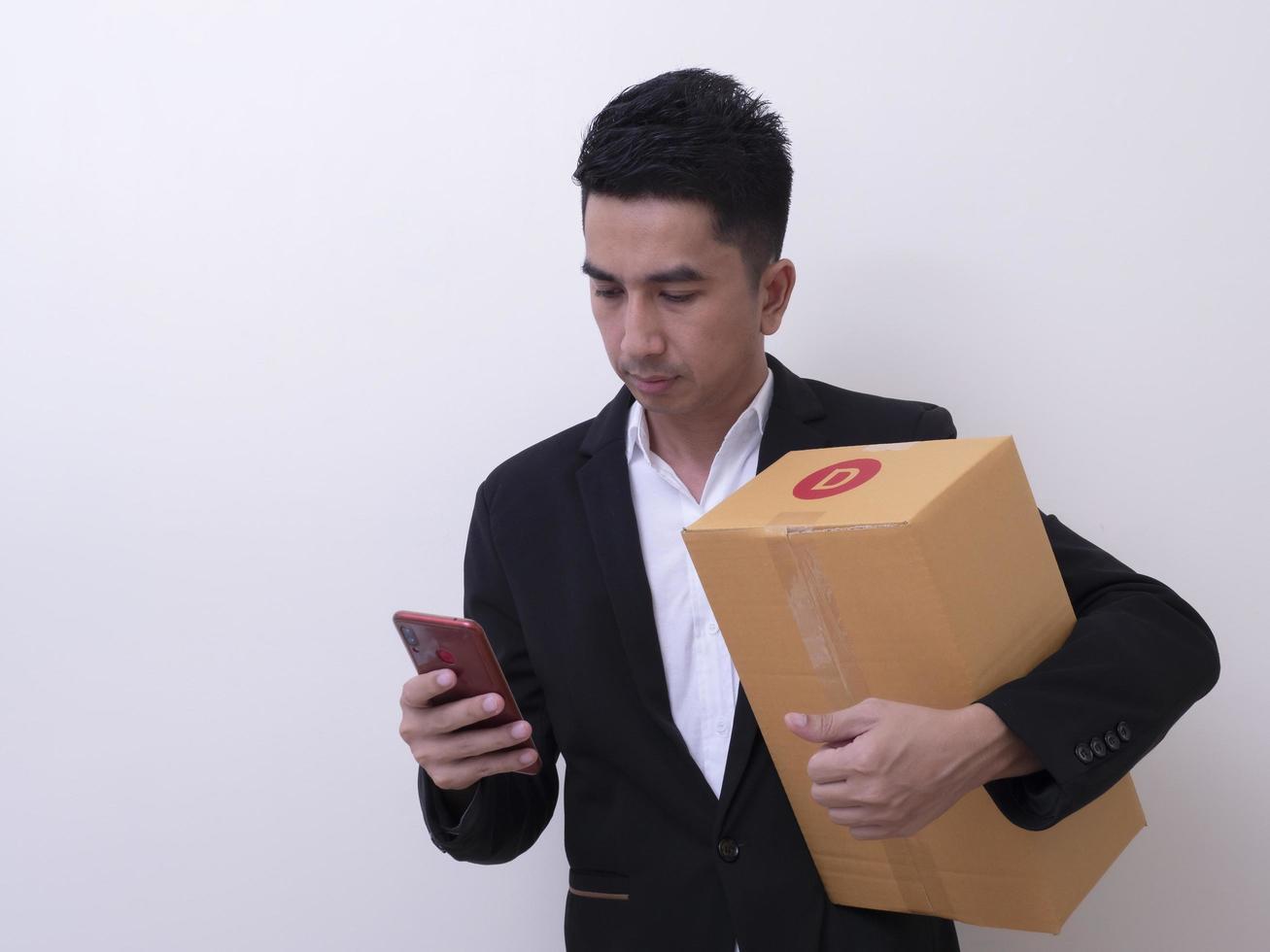 Shipper young Asian man holding cardboard box photo