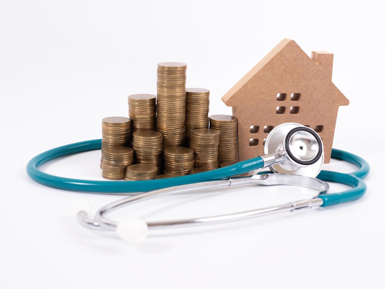 Check up house and investment concept. Stethoscope with miniature house and money photo