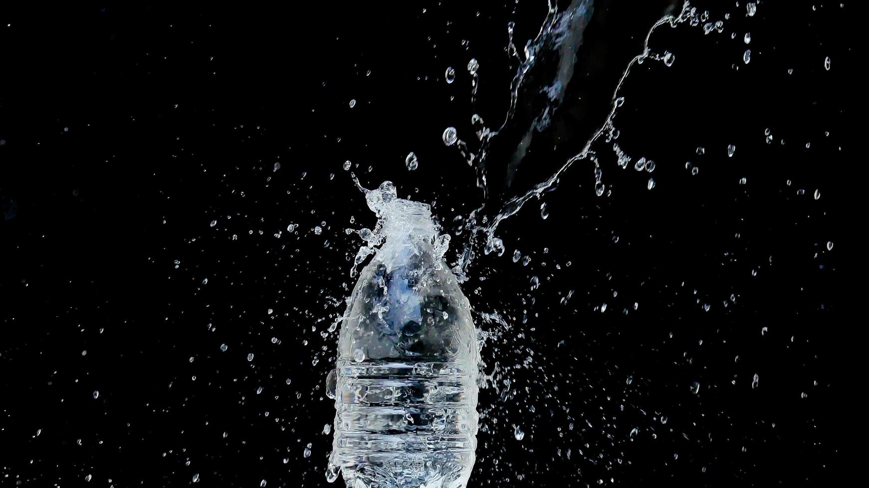 Abstract water jet crashes on a black background photo