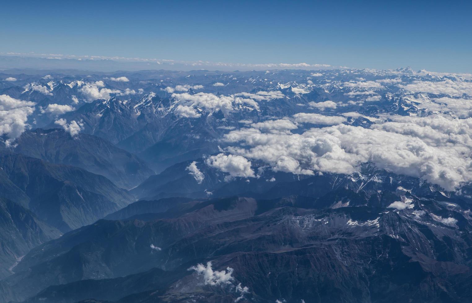 Himalaya mountains under clouds photo
