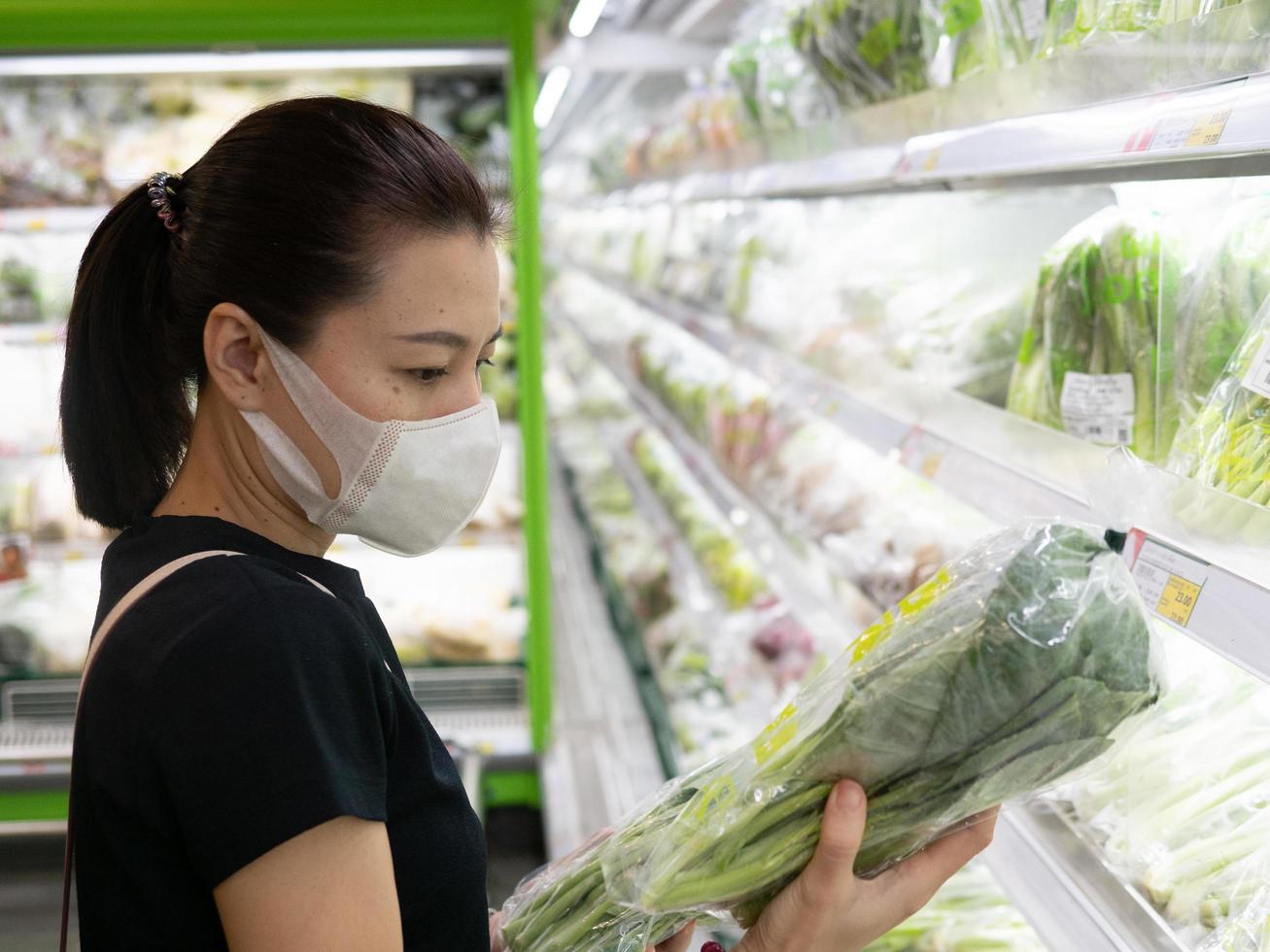 Asian woman wearing protect face mask and rubber gloves shopping food photo