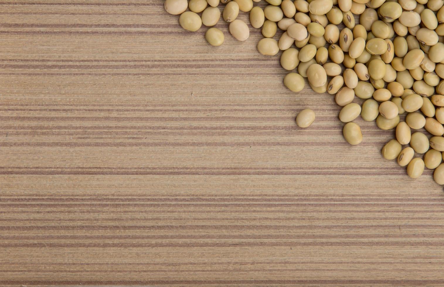 Dry soybeans on wooden board photo
