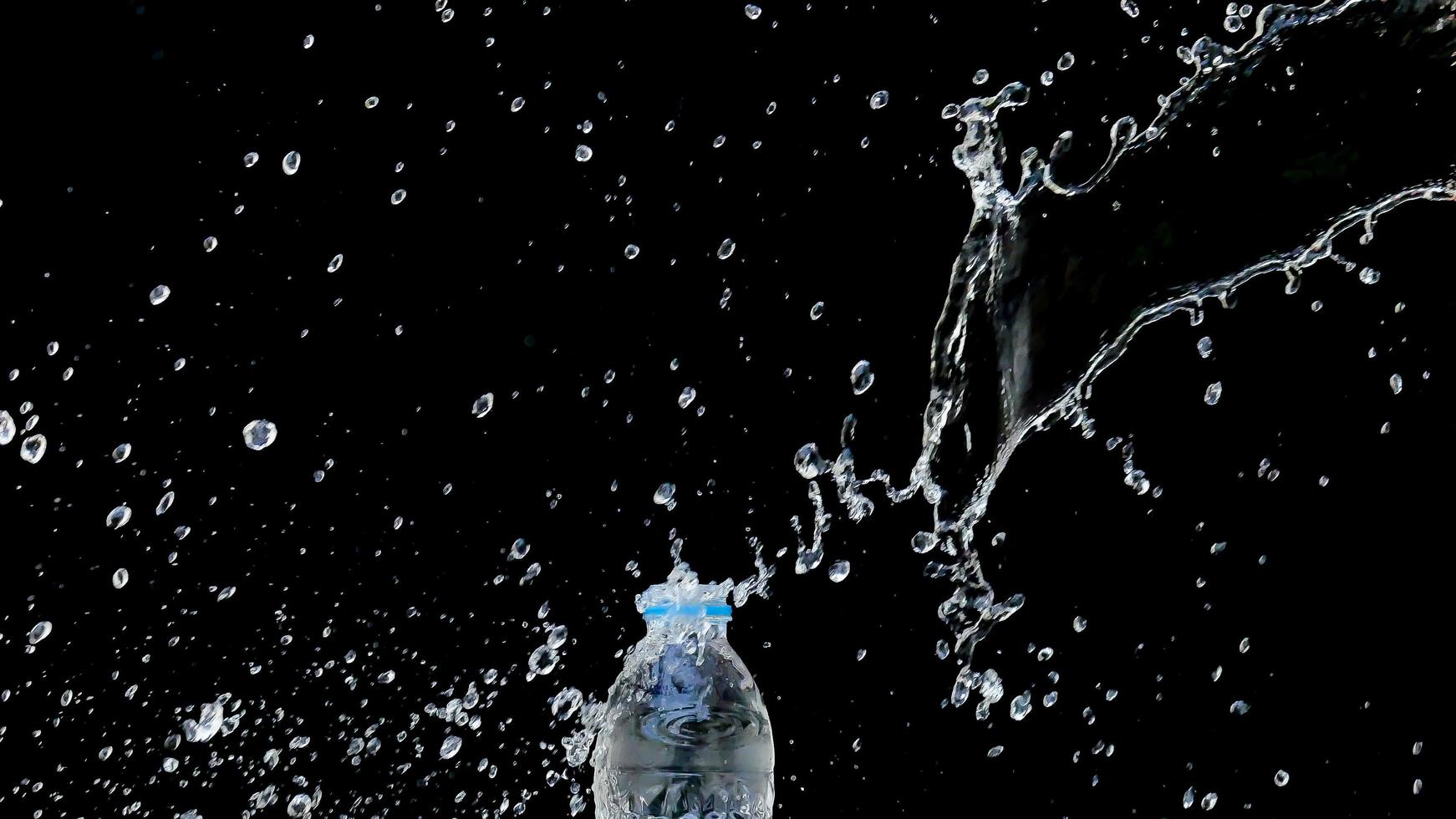 Abstract water jet crashes on a black background photo