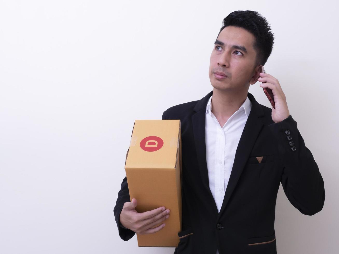 Shipper young Asian man holding cardboard box photo