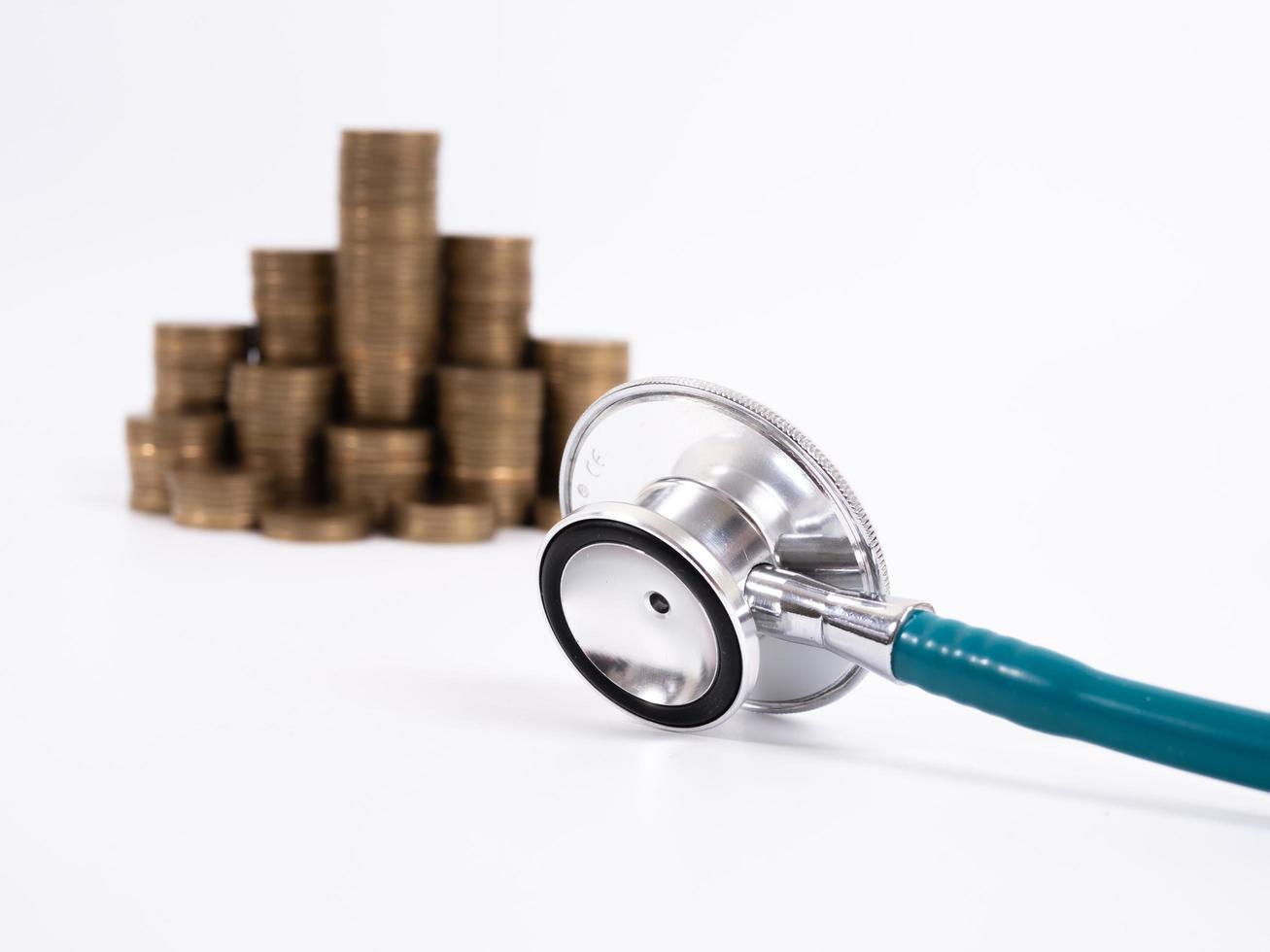 Stethoscope on coin stack, on white background. money for health care, Financial Aid, concept photo