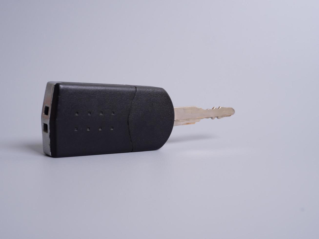 Car key with remote control isolated on gray background. photo