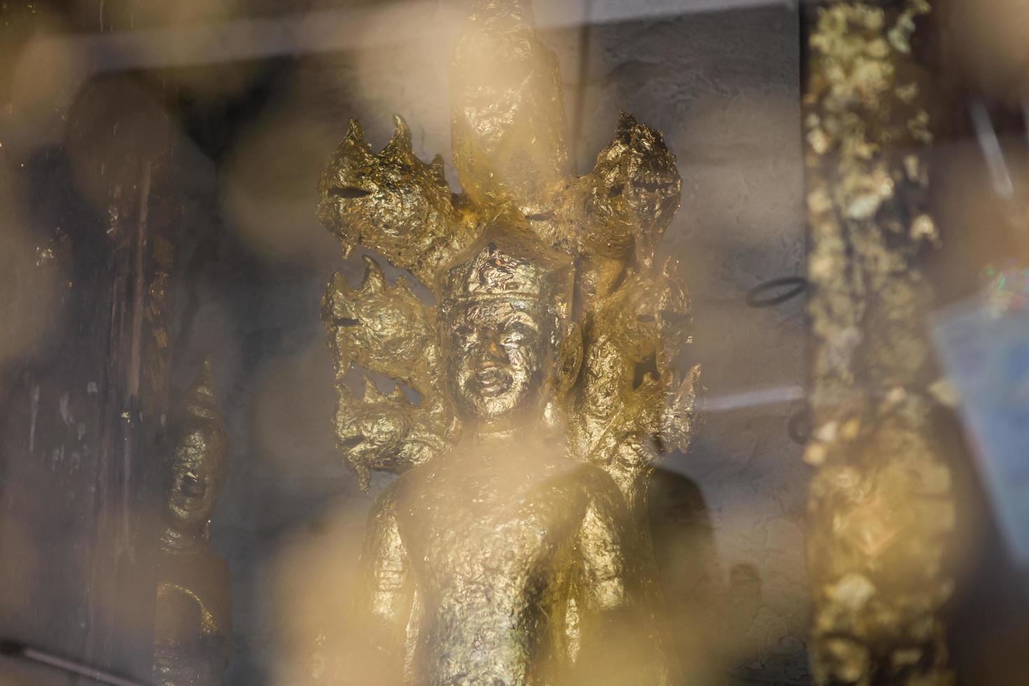 close up Buddha statue gilded in the measure photo