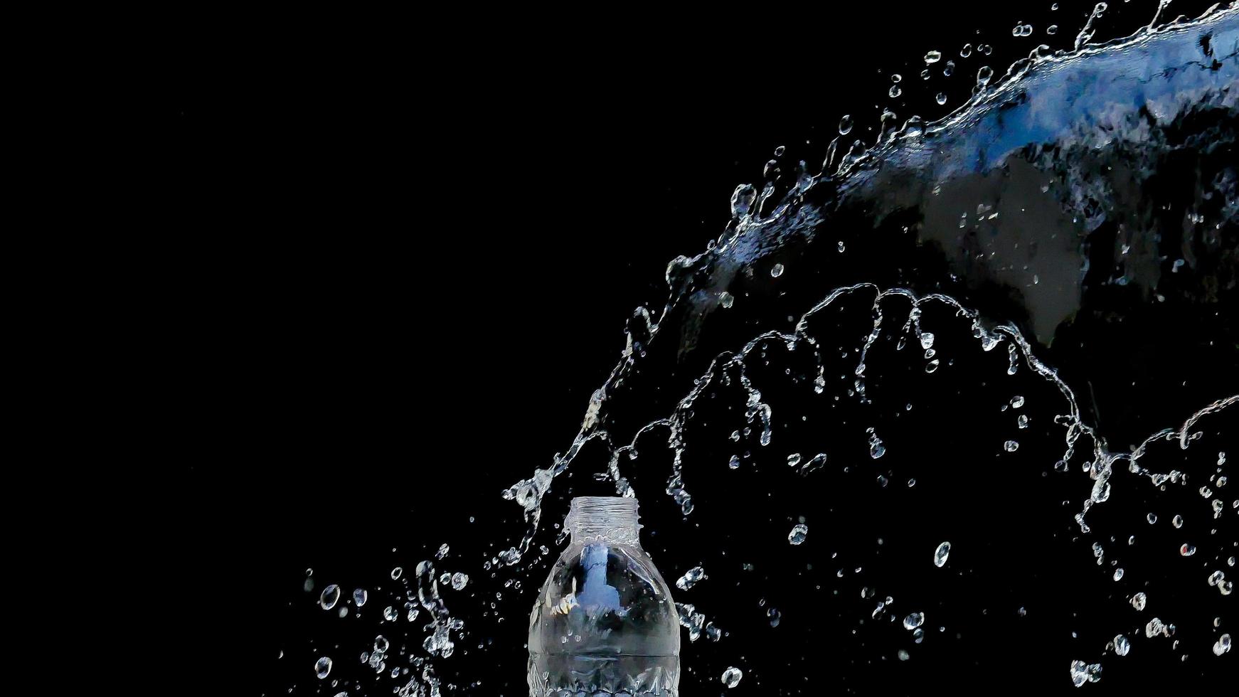 Abstract water jet crashes on a black background photo