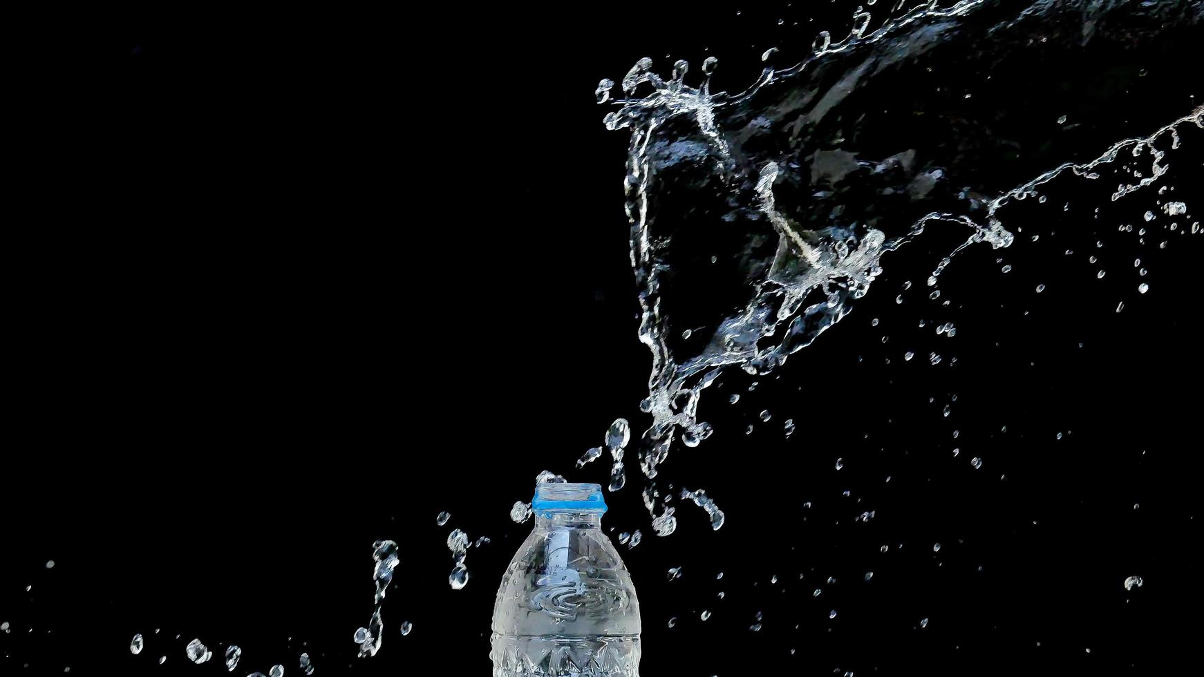 Abstract water jet crashes on a black background photo