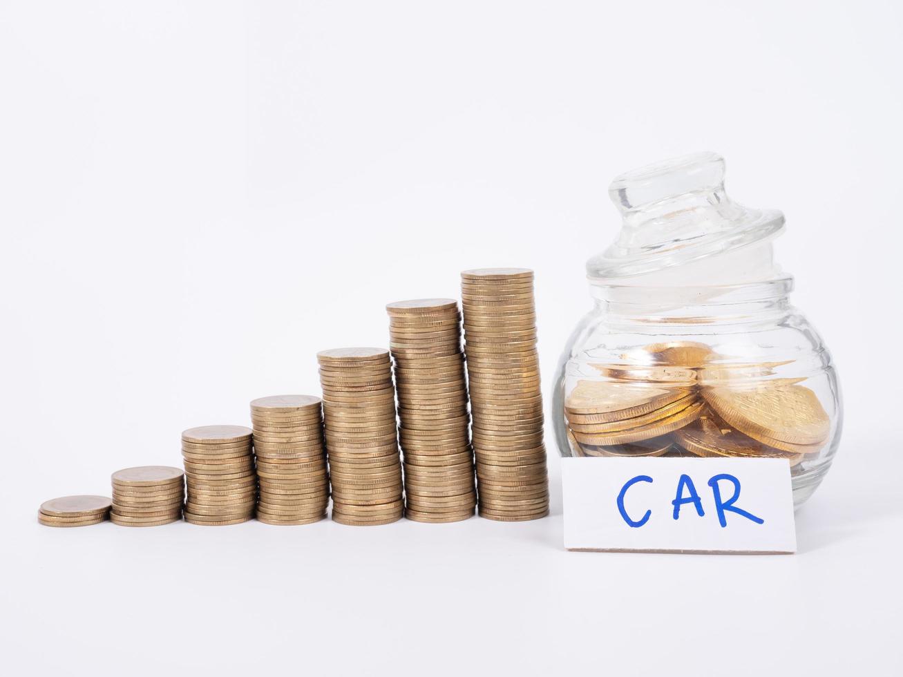money concept.save money in glass money jar with car label. photo