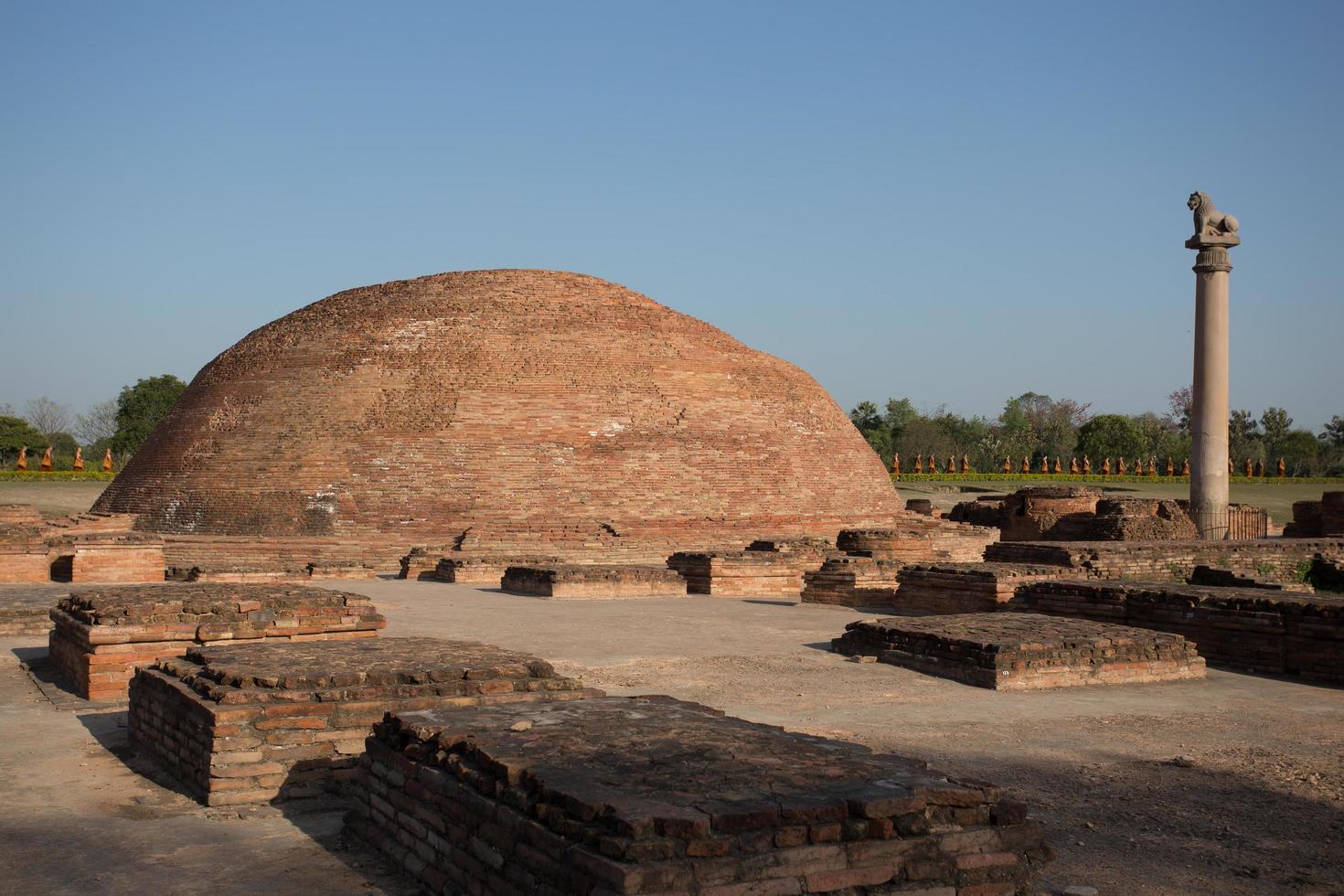 Ananda Stupa and Ashoka pillar photo