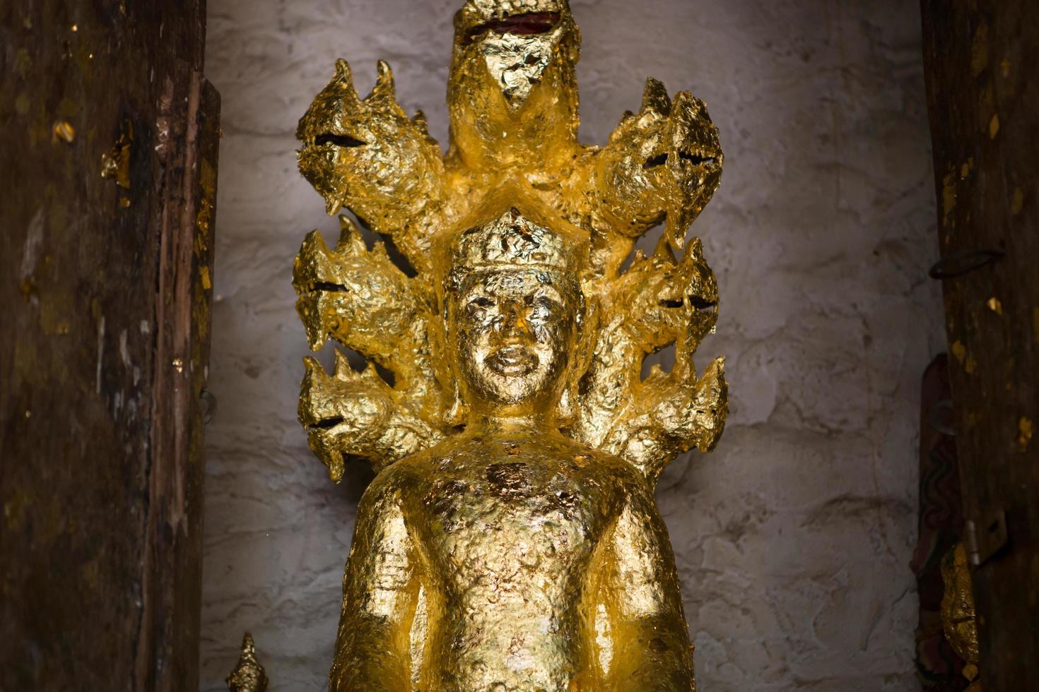 close up Buddha statue gilded in the measure photo