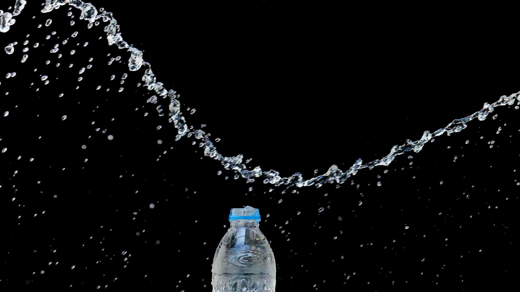 Abstract water jet crashes on a black background photo