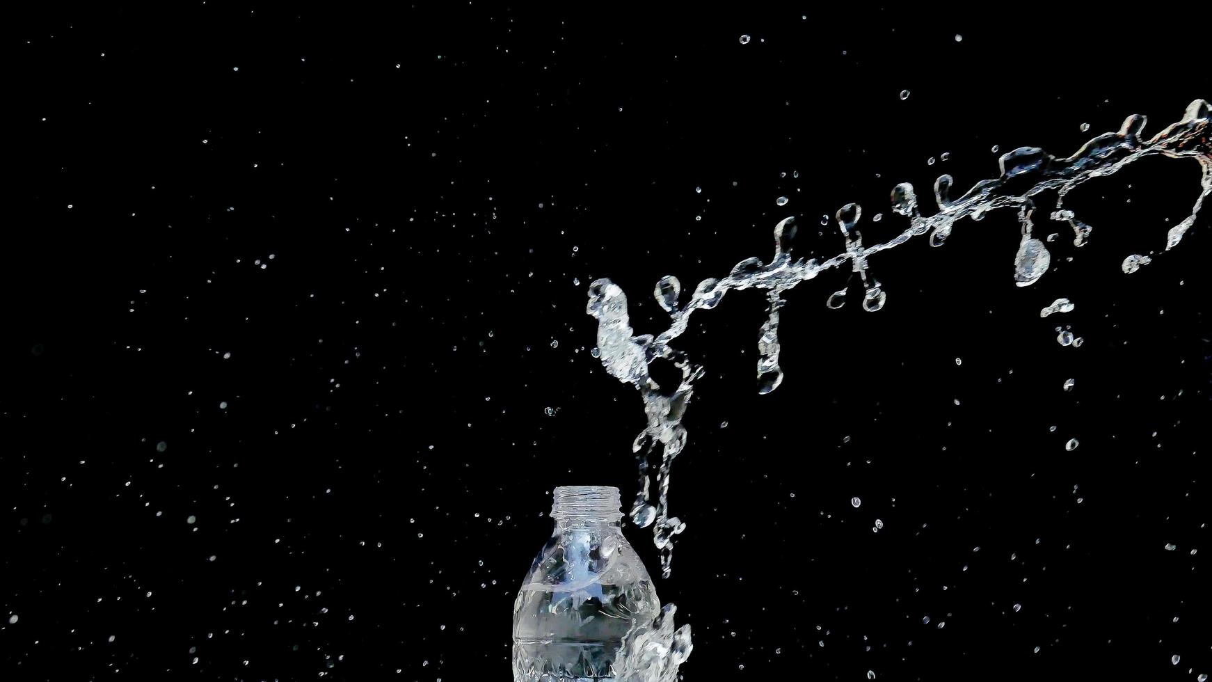 Abstract water jet crashes on a black background photo