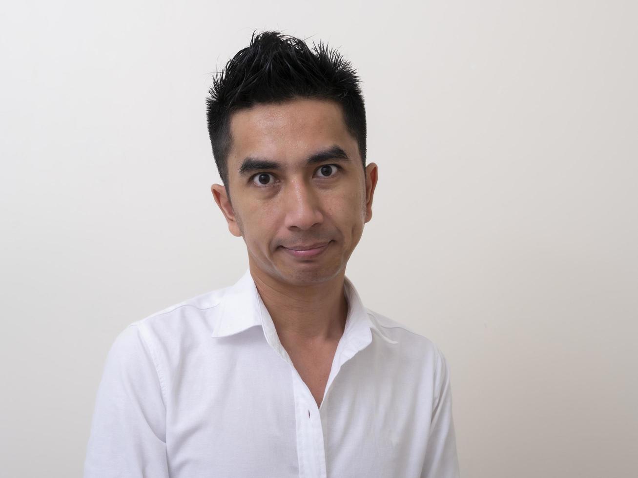 Portrait of smiling young man wearing white  shirt photo