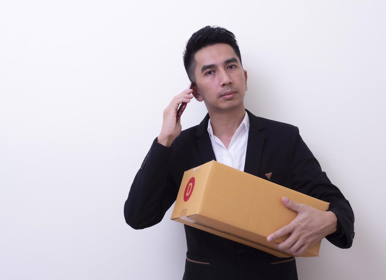 Shipper young Asian man holding cardboard box photo