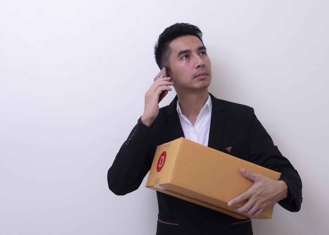 Shipper young Asian man holding cardboard box photo