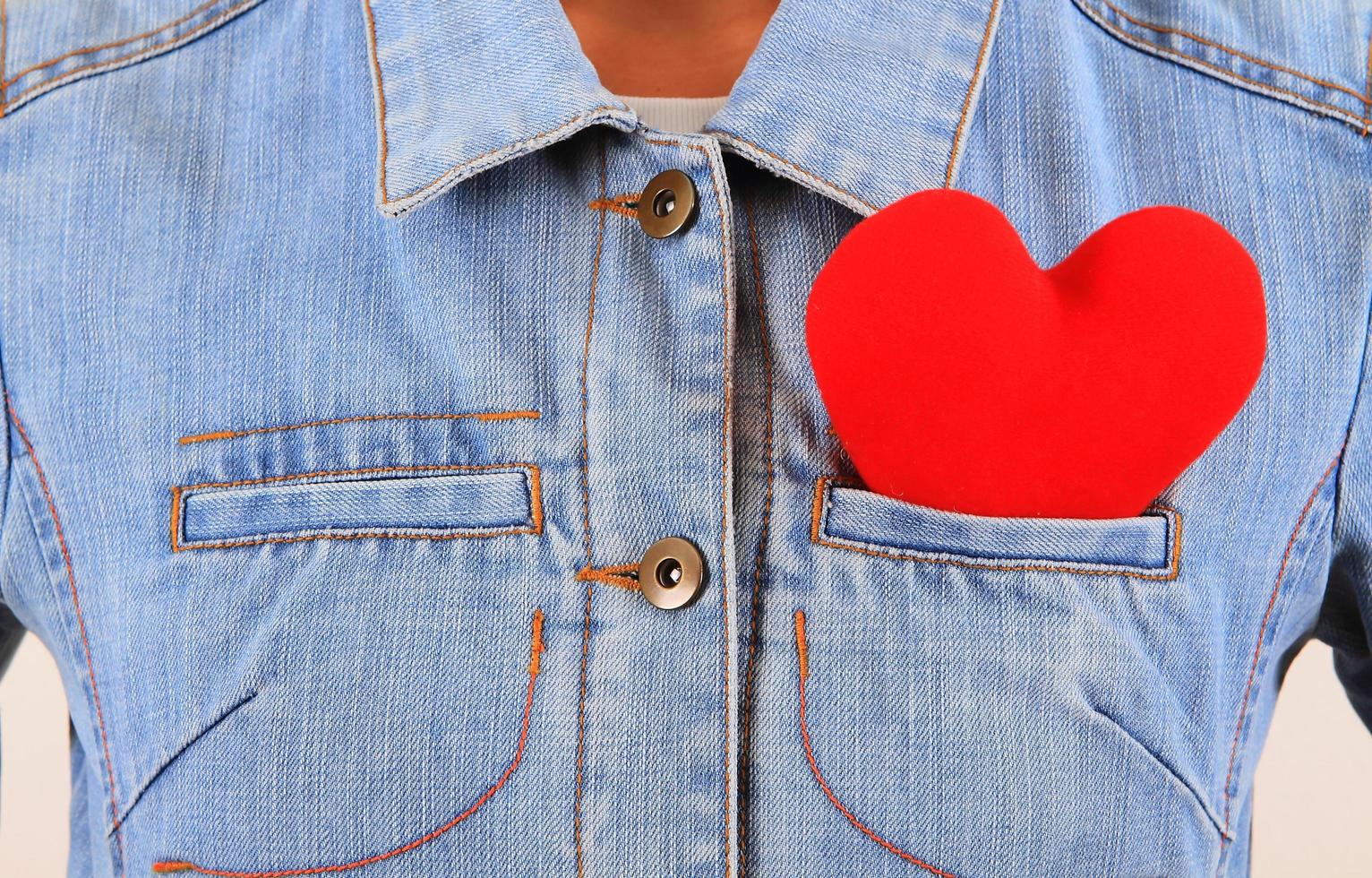 Red heart sticking out of blue jeans back pocket photo